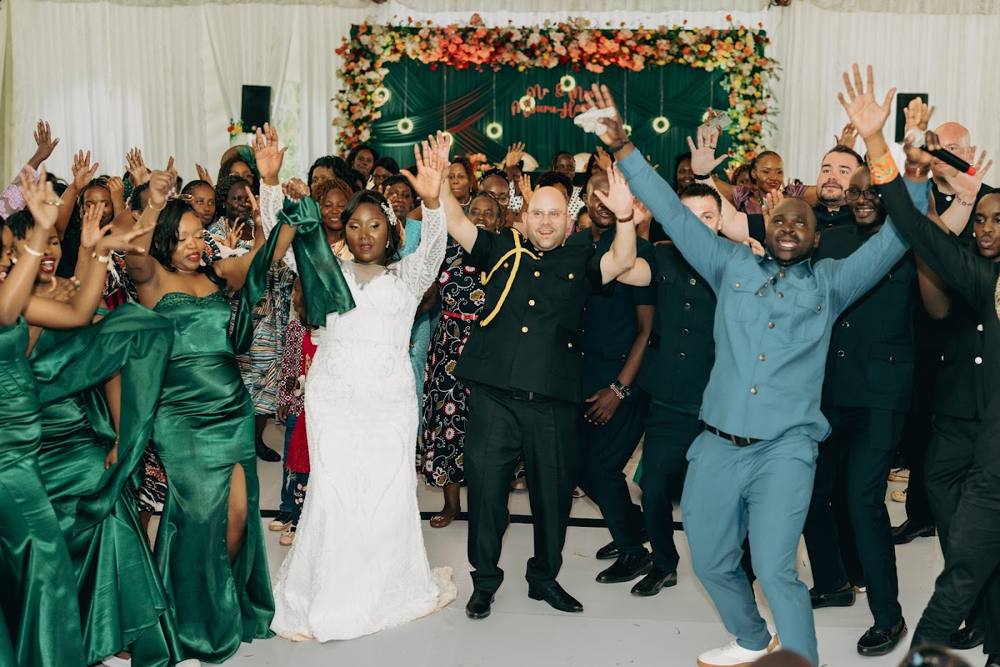 A wedding party celebrating with a bride in white
